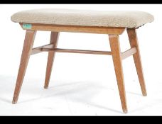 A retro 20th century oak dressing table stool with teak effect being raised on angular splayed legs