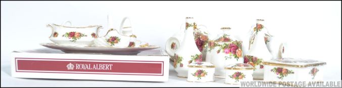 A collection of Royal Albert Country Roses bone china to include tea cups and saucers, small vases,