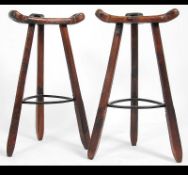 A pair of stunning 20th century black forest Arts and Crafts inspired bar / breakfast bar stools