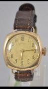 A vintage mens Ingersoll Rolled gold watch with brown leather strap.