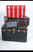 A collection of three vintage 20th century steamer trunks.