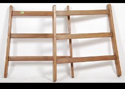 A pair of vintage early 20th century wide wooden fruit ladder display bases / display racks with