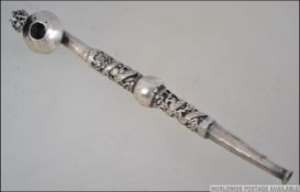 A Chinese silver opium pipe being embellished with dragons having round bowl with dragons head.
