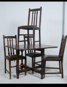 A set of 4 Edwardian Arts & Crafts oak Liberty style dining chairs raised on square tapered legs