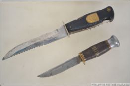 A German made Solingen multi bladed hunting knife along with another vintage hunting knife both in