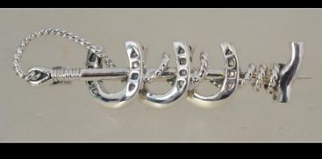 A silver horse - hunting brooch in the form of a riding crop and 3 horse shoes.