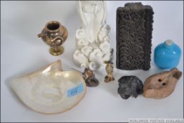 A group of items to include an antique clay oil lamp,
