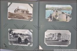 A good postcard album containing mostly Devon and Cornwall examples, postcards of abbeys ,