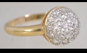 An 18ct gold ring set with a clear stone encrusted dome. Weight 5g. Size U.