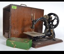 Patented American vintage sewing machine with Singer spares and other parts in vintage tin .