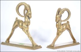 A pair of 20th cenutry brass gazelle book ends, each raised on plinth brass bases.
