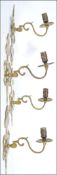 A pair of mid 20th century gilt cast brass / metal twin wall sconces in the rococo style.
