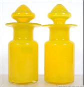 A fabulous pair of Uranium lidded bon bon jars. Of cylindrical form with large stoppers.