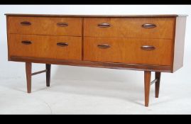 A retro 20th century 1970's teak wood sideboard having an arangment of drawers and cupboards raised