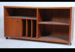 A retro low teak sideboard - media unit having sliding doors with lined interior and spaces for
