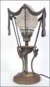 A Victorian style classical table lamp with cone glass shade and swag design and raised on