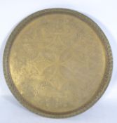 A large 19th century central European brass engraved salver tray with pierced gallery having an