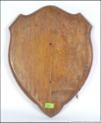 A vintage early to mid 20th century oak armorial shield back with great patina.