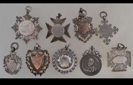 A collection of silver hallmarked armorial pocket watch fobs - plaques,