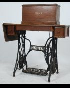 A Singer sewing machine circa 1900, with iron A Singer sewing machine circa 1900,