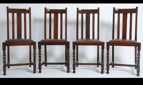 A set of 4 1930's oak barley twist dining chairs with removable seating pads being raised on