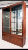 A late 19th century mahogany and mirror lined chemists shop display cabinet.