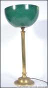 A vintage brass bankers desk lamp with neo classical style lamp base and two tone uplighting green
