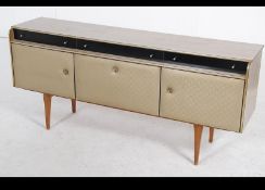 A mid century retro / vintage melamine sideboard dresser being raised on tapered legs with