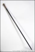 A 19th century silver collar ebonised malacca walking stick with horn handle.