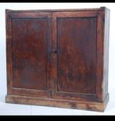 A retro early 20th century Industrial school cupboard with twin doors enclosing a shelved interior