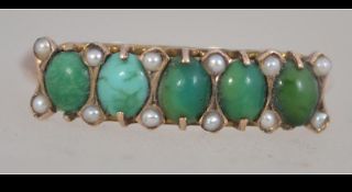 A 9ct gold turquoise and seed pearl ladies dress ring. Marked 9ct to the band.