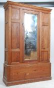 A Victorian pitch pine wardrobe - armoire having a plinth drawer base with upright wardrobe above.