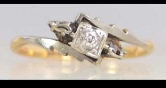 An early 20th century 18ct gold and platinum diamond ring set with a central diamond with