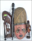 A collection of tribal artefacts to include a wooden mask, figurine, wooden dagger etc.