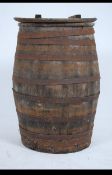 An early 20th century oak coopered barrel of bulbous form complete with the wooden lid.