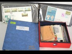 A group of various stamps held within an album with some loose.