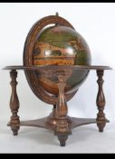 A 20th century antique style terrestrial Italian made desk top globe raised on fruitwood gimbal