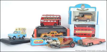 A collection of play worn tinplate cars to include Chitty Chitty bang bang,