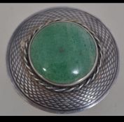 A Scottish silver and jade hallmarked roundel brooch.