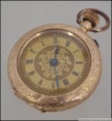 An early 20th century 14ct gold ladies crown wind fob watch having faceted hands with roman numeral