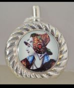 A silver and enamel set perfume bottle of roundel form with top having applied enamel pictorial of