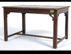 A mahogany leather topped campaign style rectangular table with pierced supports,