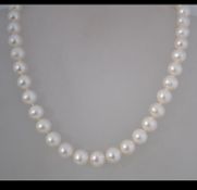 A fine cultured pearl necklace with a gilt silver ball clasp. Weight 61.
