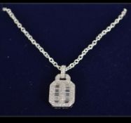 A ladies contemporary silver and baguette cz adorned pendant and silver necklace. Weight 3.