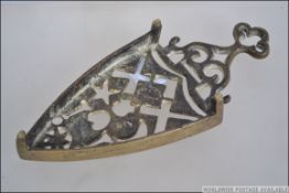 A brass trivet cast with masonic symbols dating to the late 19th century. Measures 21cms long.