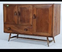 An Ercol light elm and beech sideboard Circa 1950's, having two drawers above three cupboard doors,