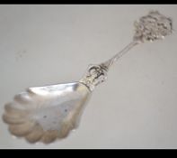 A silver 800 marked continental caddy spoon with twist stem ship handle and oyster bowl.