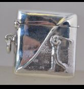 A sterling silver case with embossed golfer to the top. Striker to the base with hinged top.