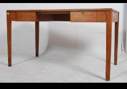 A mid century golden oak Air Ministry military desk raised on tapered legs with drawers to the