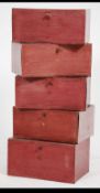 A stack of mid century vintage office leather clad stacking cases - filing boxes in oxblood red